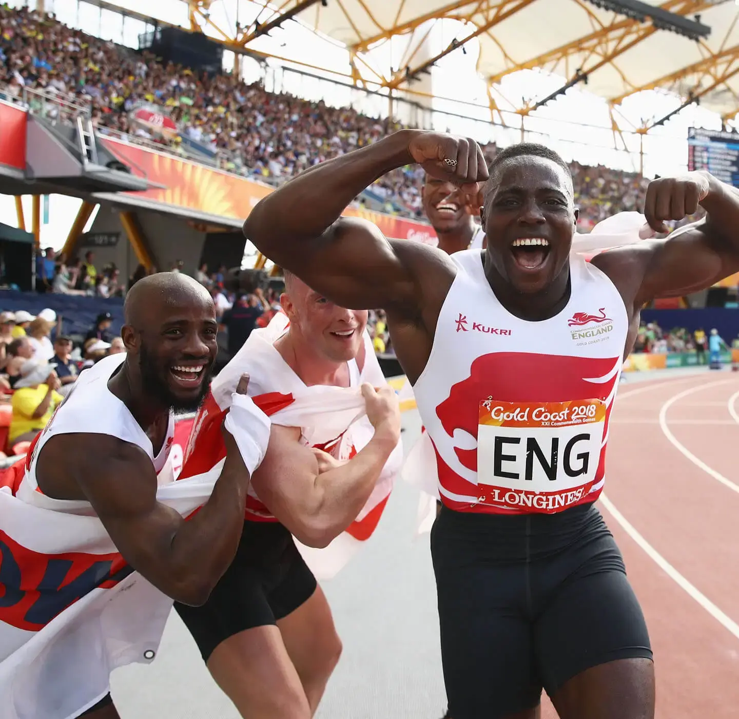 Team England athletes celebrating on the track