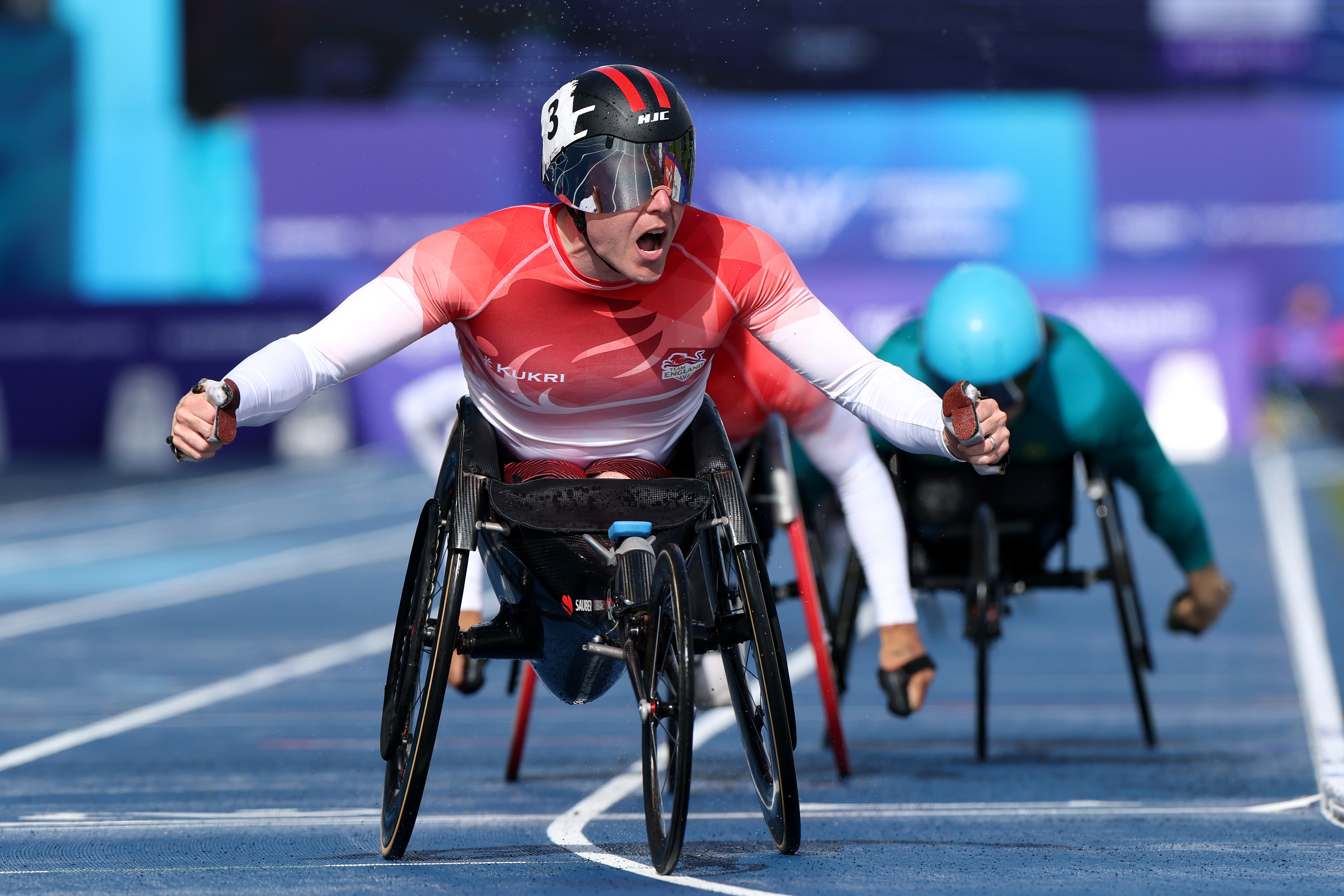 Team England athletes celebrating on the track